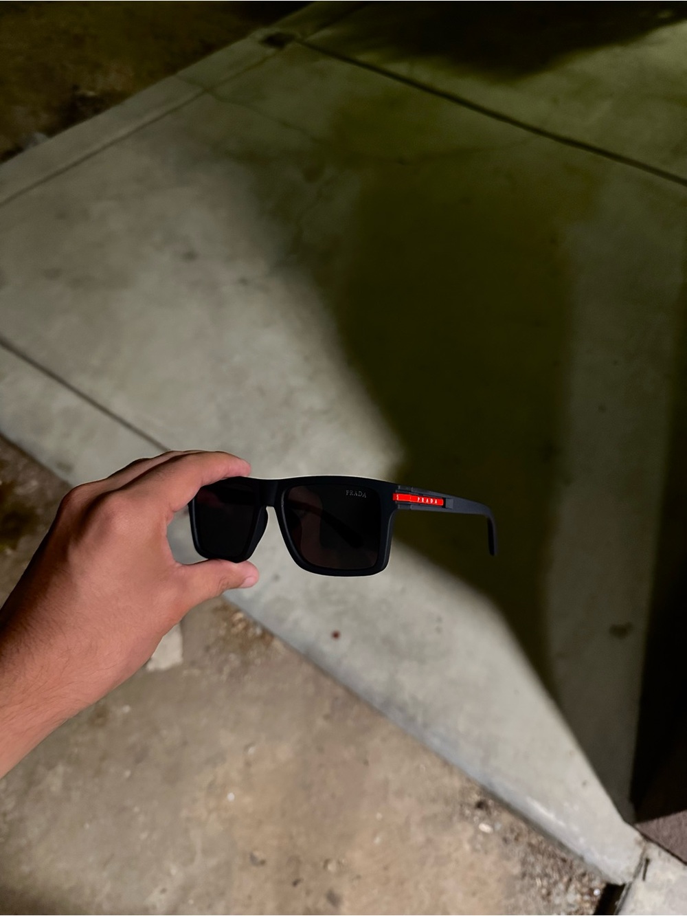 Prada Men’s Black Sunglasses with Red Temple Detail